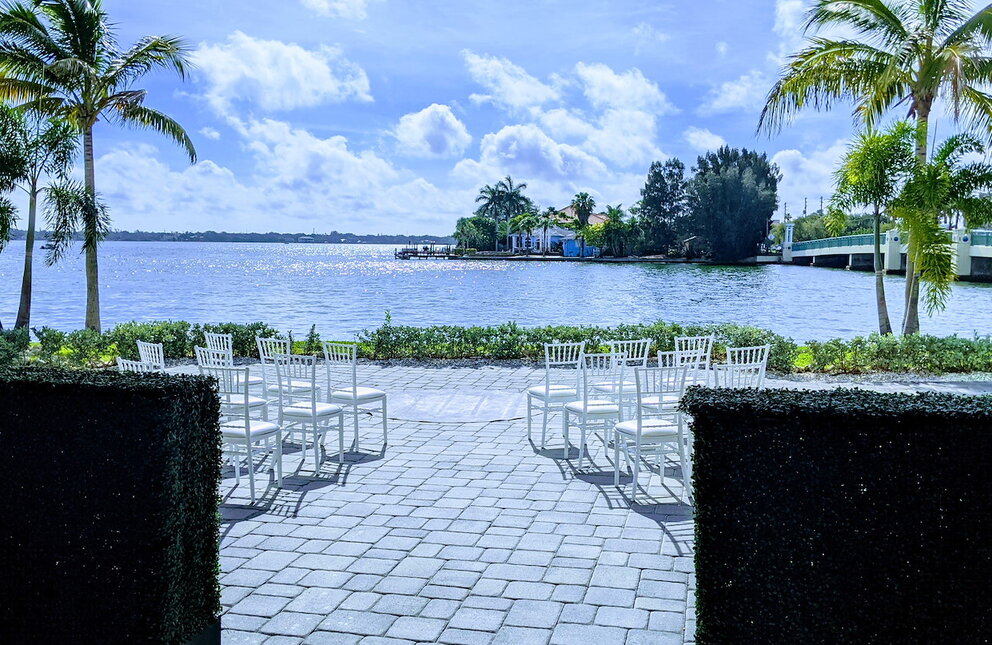 Outside wedding venue looking down the aisle with bay water backdrop