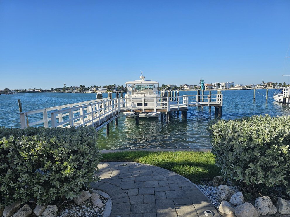 a dock with a boat on the water